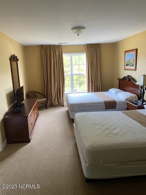 bedroom featuring light carpet