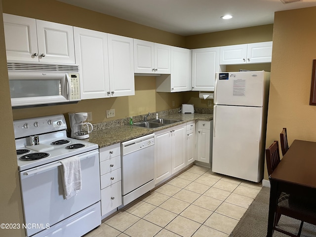 kitchen featuring white appliances, a sink, white cabinetry, light tile patterned floors, and recessed lighting