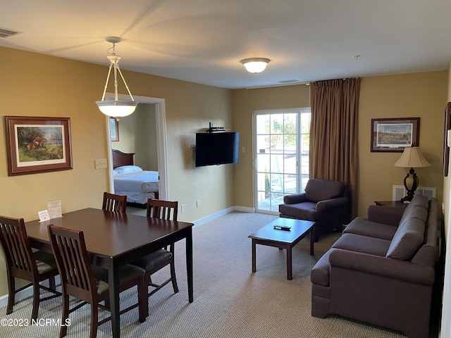 dining room with light carpet and baseboards