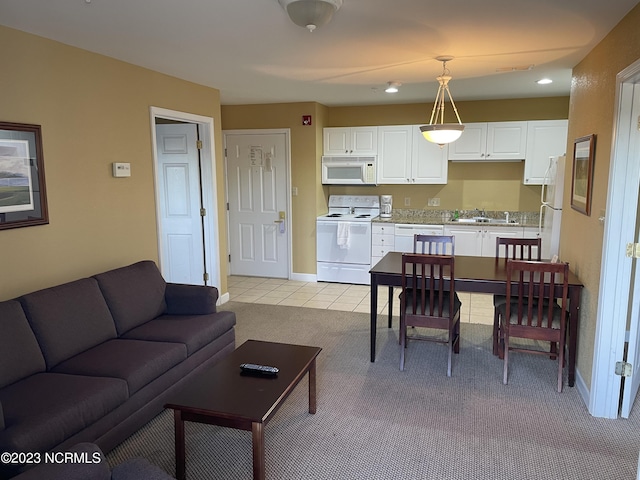 living room featuring light colored carpet, light tile patterned flooring, recessed lighting, and baseboards