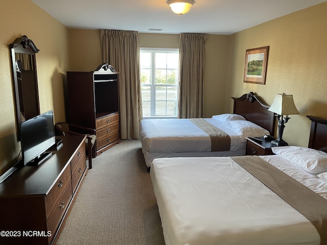 carpeted bedroom with an office area