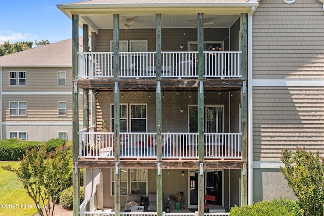 rear view of house featuring a balcony and a patio