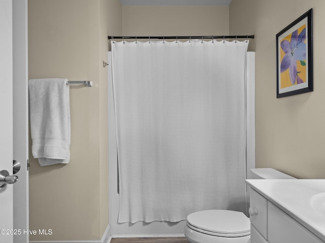 full bathroom with toilet, vanity, and shower / tub combo with curtain