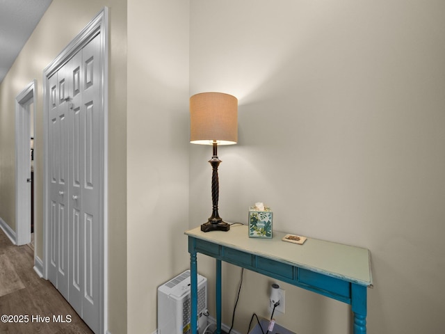 hall with dark wood finished floors and baseboards