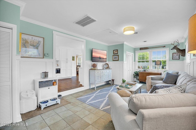 125 Windemere Rd, Wilmington, NC 28405 - living room with wainscoting, a decorative wall, crown molding, attic access, and tile patterned floors