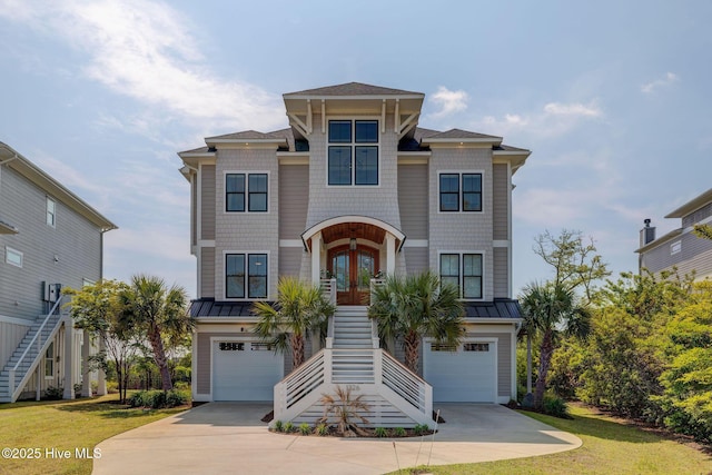 1326 Tidalwalk Dr, Wilmington, NC 28409 - coastal home with stairs, french doors, concrete driveway, and a standing seam roof