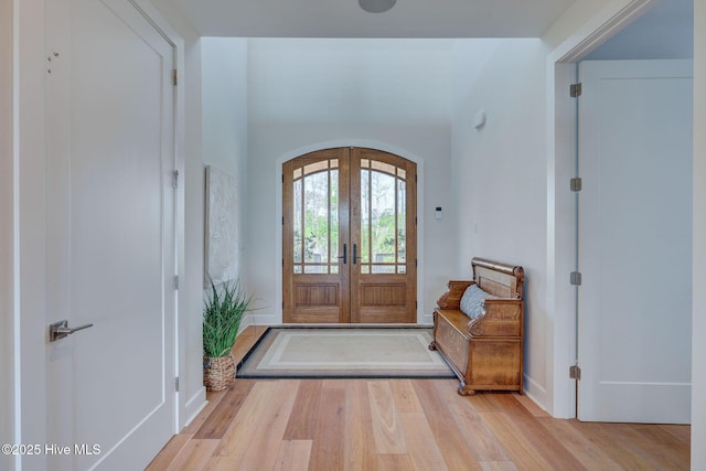 1326 Tidalwalk Dr, Wilmington, NC 28409 - foyer featuring arched walkways, wood finished floors, and french doors