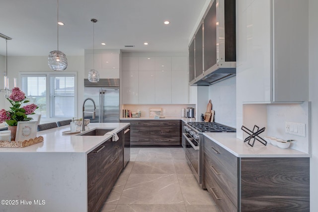 1326 Tidalwalk Dr, Wilmington, NC 28409 - kitchen featuring premium appliances, modern cabinets, a sink, wall chimney exhaust hood, and white cabinets