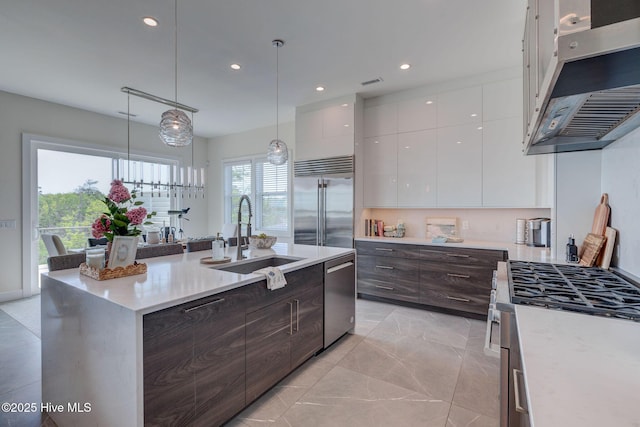 1326 Tidalwalk Dr, Wilmington, NC 28409 - kitchen featuring a sink, stainless steel appliances, under cabinet range hood, modern cabinets, and white cabinets