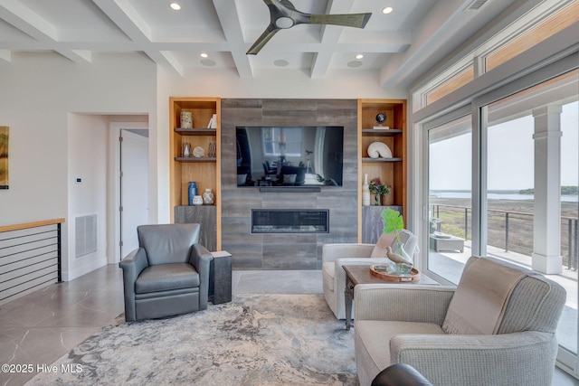 1326 Tidalwalk Dr, Wilmington, NC 28409 - living room featuring a glass covered fireplace, healthy amount of natural light, coffered ceiling, a ceiling fan, and beamed ceiling