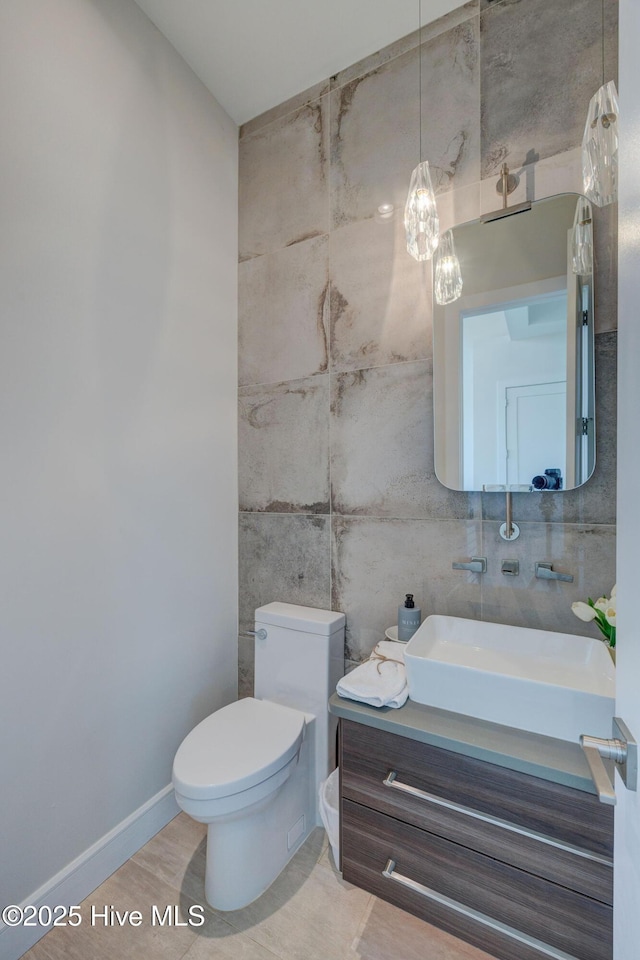1326 Tidalwalk Dr, Wilmington, NC 28409 - half bath featuring tile walls, vanity, toilet, and a chandelier