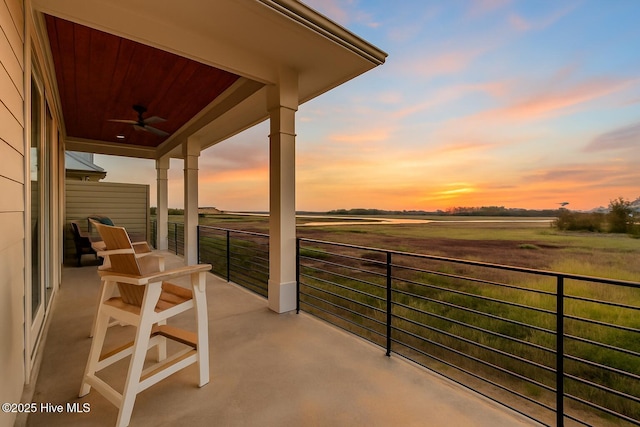 1326 Tidalwalk Dr, Wilmington, NC 28409 - balcony at dusk featuring a ceiling fan and a view of rural / pastoral area