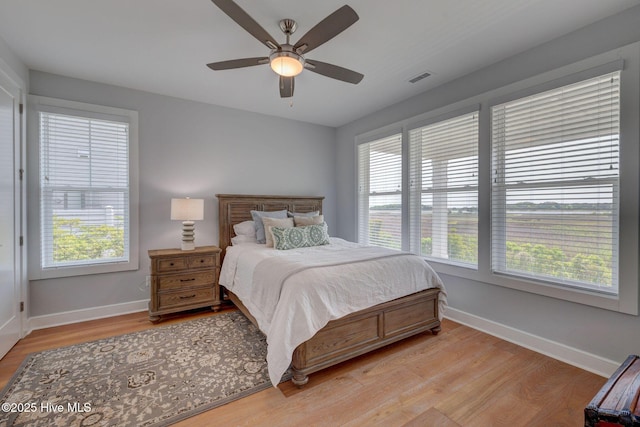 1326 Tidalwalk Dr, Wilmington, NC 28409 - bedroom with light wood-style flooring, baseboards, and a ceiling fan