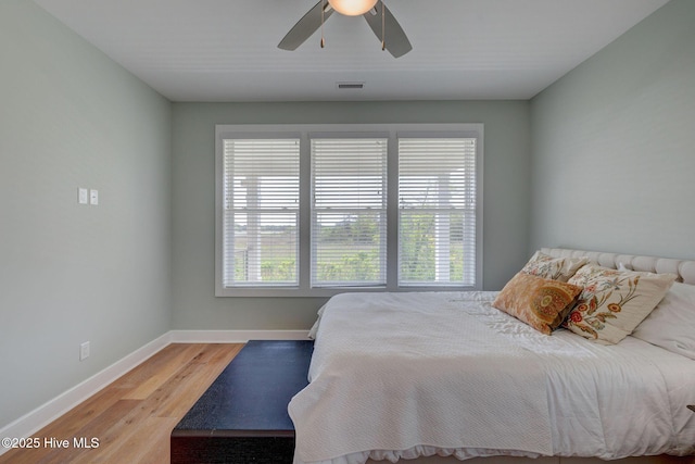 1326 Tidalwalk Dr, Wilmington, NC 28409 - bedroom with baseboards, wood finished floors, and a ceiling fan