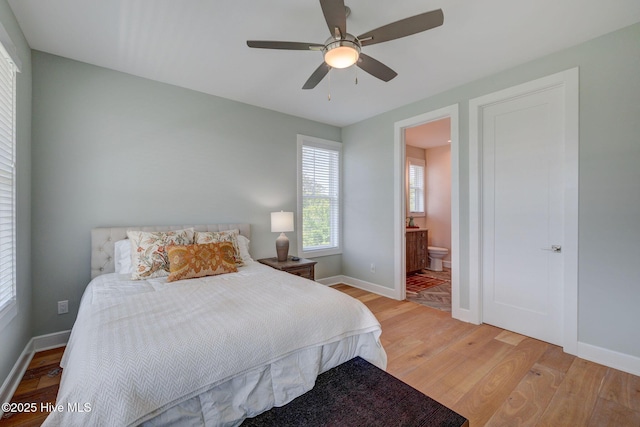 1326 Tidalwalk Dr, Wilmington, NC 28409 - bedroom featuring light wood-type flooring, baseboards, connected bathroom, and a ceiling fan