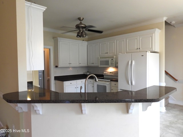 644 Milton Dr, Winterville, NC 28590 - kitchen with white appliances, a peninsula, crown molding, dark countertops, and a breakfast bar