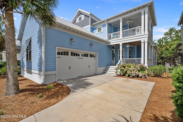 1218 Pinfish Ln, Carolina Beach, NC 28428 - view of front facade with a porch, a balcony, ceiling fan, a garage, and driveway