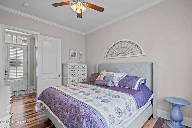 1218 Pinfish Ln, Carolina Beach, NC 28428 - bedroom with wood finished floors, crown molding, baseboards, and a ceiling fan