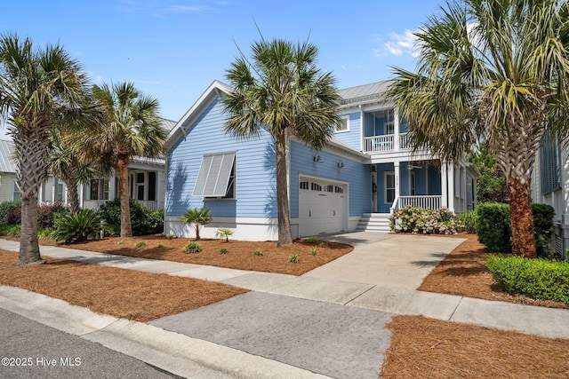 1218 Pinfish Ln, Carolina Beach, NC 28428 - view of front of home with a porch, a balcony, an attached garage, and concrete driveway