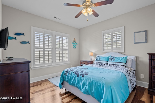 1218 Pinfish Ln, Carolina Beach, NC 28428 - bedroom featuring baseboards, wood finished floors, and a ceiling fan