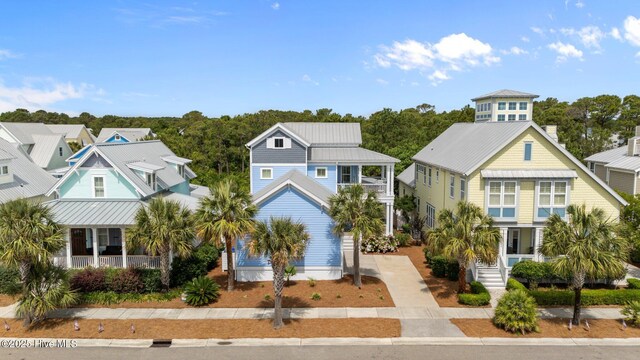 1218 Pinfish Ln, Carolina Beach, NC 28428 - raised beach house with a residential view, metal roof, covered porch, and a standing seam roof
