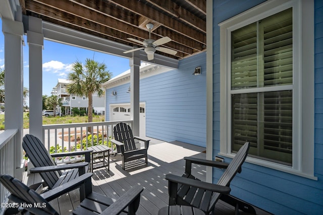 1218 Pinfish Ln, Carolina Beach, NC 28428 - porch with a ceiling fan and an attached garage