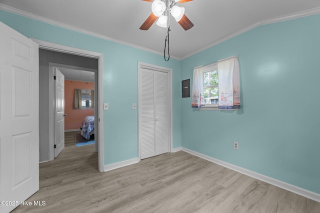2285 Old Pamlico Beach Rd W, Belhaven, NC 27810 - unfurnished bedroom with ornamental molding, light wood finished floors, a closet, baseboards, and a ceiling fan