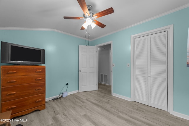 2285 Old Pamlico Beach Rd W, Belhaven, NC 27810 - bedroom featuring light wood-style floors, baseboards, crown molding, a closet, and vaulted ceiling