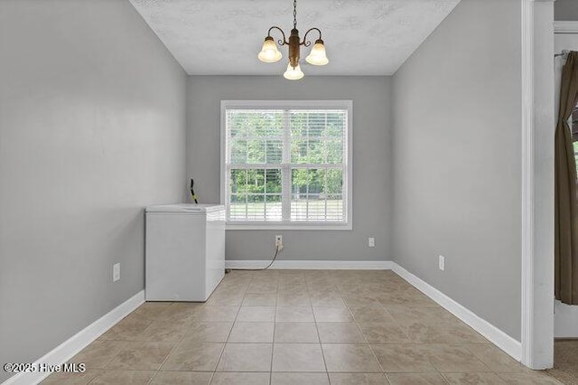 102 Rocky Ct, Richlands, NC 28574 - spare room with a chandelier, baseboards, and light tile patterned flooring
