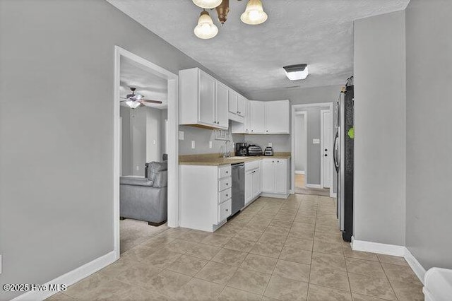 102 Rocky Ct, Richlands, NC 28574 - kitchen with white cabinetry, baseboards, stainless steel appliances, and light countertops