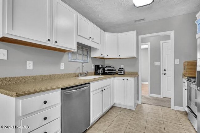 102 Rocky Ct, Richlands, NC 28574 - kitchen with stainless steel appliances, a sink, white cabinetry, a textured ceiling, and light tile patterned floors