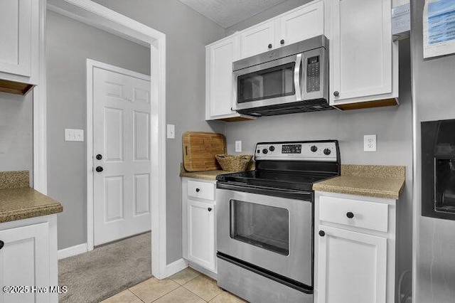 102 Rocky Ct, Richlands, NC 28574 - kitchen featuring appliances with stainless steel finishes, white cabinetry, baseboards, and light tile patterned floors