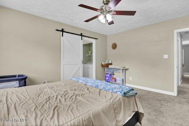 102 Rocky Ct, Richlands, NC 28574 - bedroom featuring a barn door, carpet flooring, baseboards, a textured ceiling, and washer / dryer