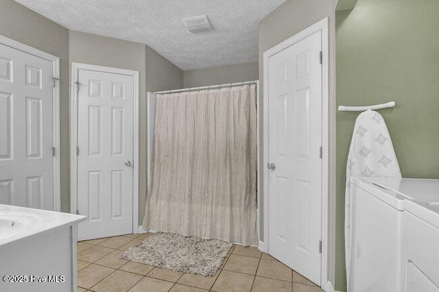 102 Rocky Ct, Richlands, NC 28574 - full bath featuring washing machine and dryer, tile patterned floors, vanity, curtained shower, and a textured ceiling