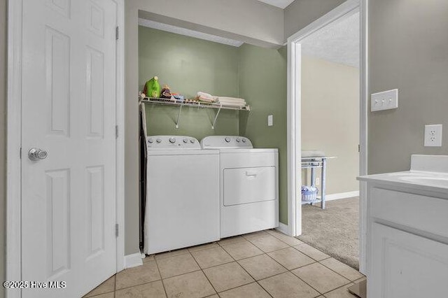 102 Rocky Ct, Richlands, NC 28574 - laundry area with washer and dryer, light tile patterned flooring, baseboards, and light colored carpet