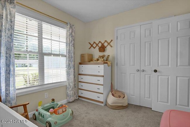 102 Rocky Ct, Richlands, NC 28574 - carpeted bedroom featuring multiple windows, a closet, and baseboards