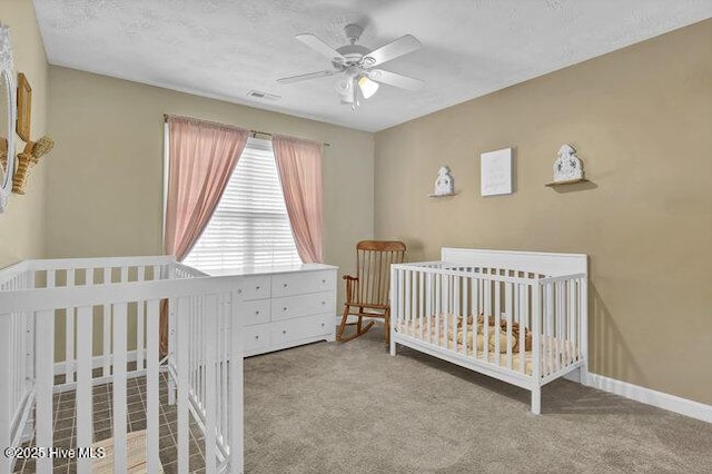 102 Rocky Ct, Richlands, NC 28574 - bedroom featuring carpet flooring, ceiling fan, baseboards, and a nursery area