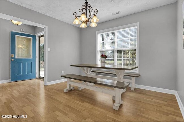 102 Rocky Ct, Richlands, NC 28574 - dining area featuring baseboards, a chandelier, and light wood-style flooring