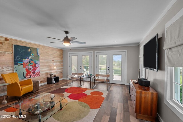 105 N Main St, Bath, NC 27808 - living room with french doors, plenty of natural light, a ceiling fan, wood walls, and wood finished floors