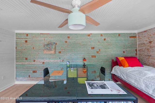 105 N Main St, Bath, NC 27808 - bedroom with wood walls, wood finished floors, ceiling fan, and baseboards