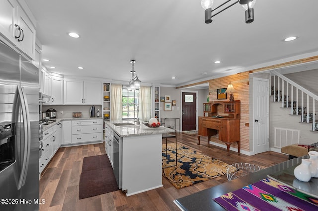 105 N Main St, Bath, NC 27808 - kitchen featuring stainless steel fridge with ice dispenser, a sink, dark wood-style flooring, open shelves, and an island with sink
