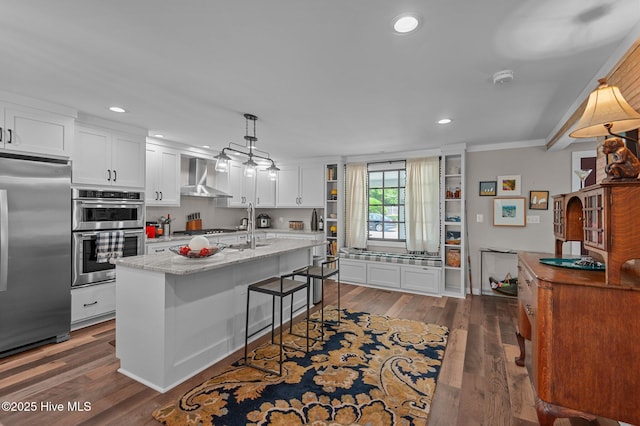 105 N Main St, Bath, NC 27808 - kitchen featuring appliances with stainless steel finishes, wall chimney exhaust hood, white cabinetry, recessed lighting, and dark wood-type flooring