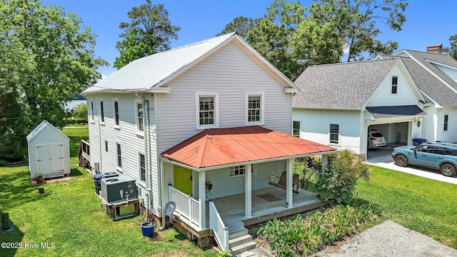 105 N Main St, Bath, NC 27808 - back of house featuring a porch, an outdoor structure, a yard, a storage unit, and a garage
