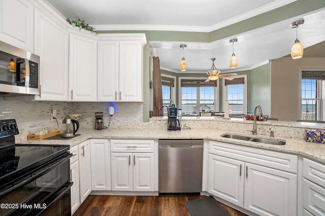 118 Durant St, Hertford, NC 27944 - kitchen featuring appliances with stainless steel finishes, a sink, crown molding, healthy amount of natural light, and white cabinetry