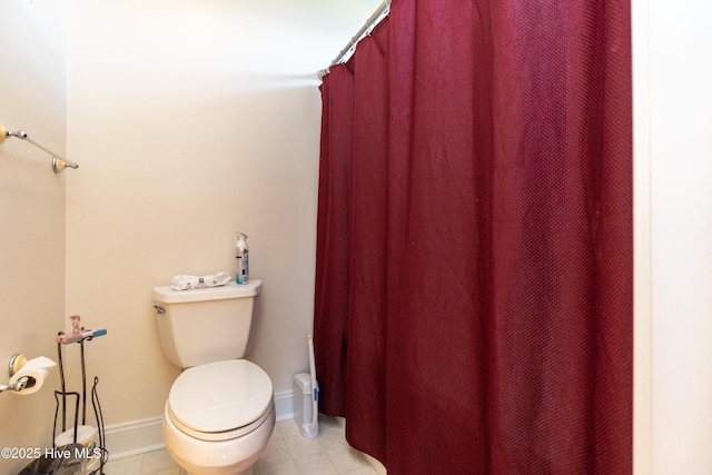 118 Durant St, Hertford, NC 27944 - bathroom with toilet, baseboards, a shower with shower curtain, and tile patterned flooring