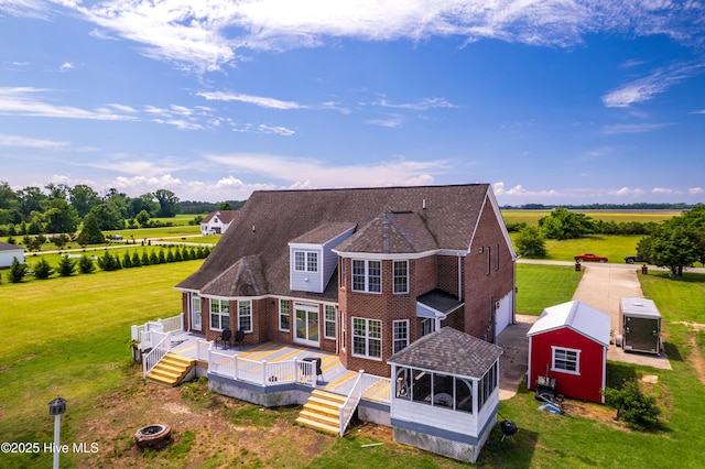 118 Durant St, Hertford, NC 27944 - rear view of property featuring a deck, brick siding, a sunroom, and a yard