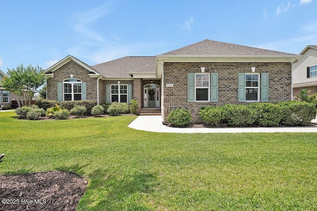 968 Woodwind Dr, Leland, NC 28451 - view of front of home with brick siding, a front lawn, and a shingled roof