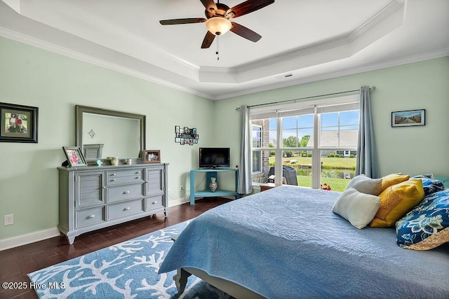 968 Woodwind Dr, Leland, NC 28451 - bedroom featuring a tray ceiling, ornamental molding, baseboards, wood finished floors, and a ceiling fan