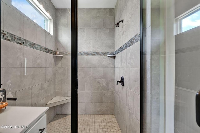 968 Woodwind Dr, Leland, NC 28451 - bathroom with plenty of natural light, a stall shower, vanity, and tile walls