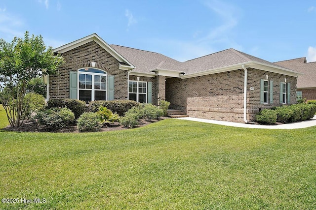 968 Woodwind Dr, Leland, NC 28451 - view of front of property with brick siding, a front yard, and roof with shingles